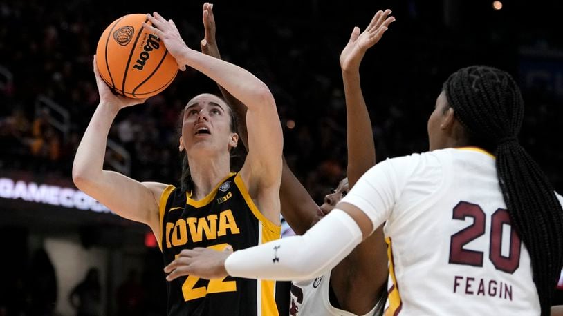 Iowa guard Caitlin Clark (22) shoots over South Carolina forward Sania Feagin (20) during the second half of the Final Four college basketball championship game in the women's NCAA Tournament, Sunday, April 7, 2024, in Cleveland. (AP Photo/Morry Gash)