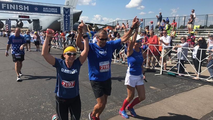 Maj. Ivan Castro (retired) finishes the 2017 Air Force Marathon. To his side are Darlene Matos on his left and Jackie Ferguson on his right while Tom Yoe follows behind. Castro, who was blinded while serving in Iraq in 2006, is the only blind Special Forces officer in U.S. Army history. Tom Archdeacon/contributed