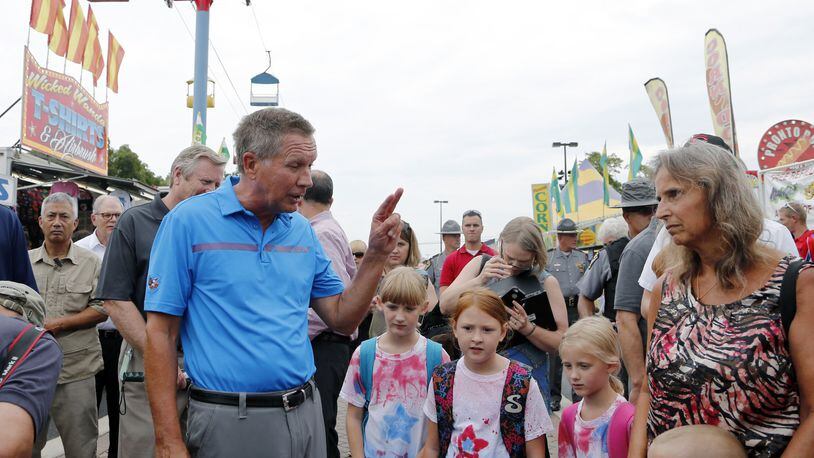 Ohio Gov. John Kasich talks with fairgoers while he tours the Ohio State Fair, Thursday, July 27, 2017, in Columbus. (AP Photo/Jay LaPrete)