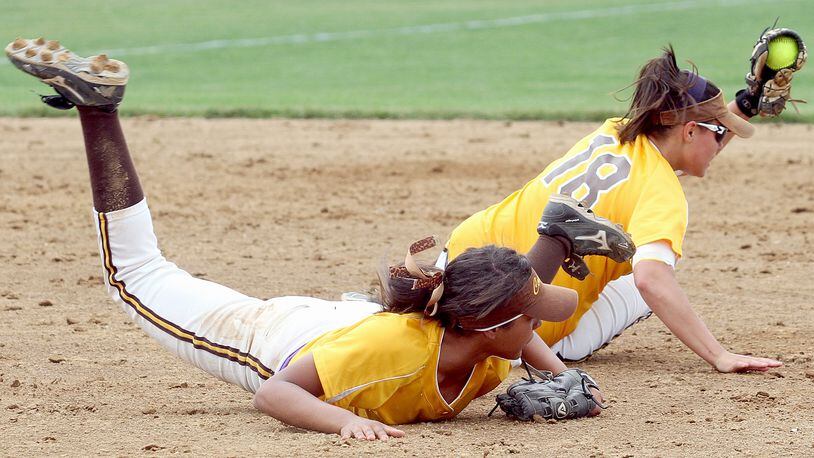 Kenton Ridge second baseman Monika Foster holds on to a Greenville ground ball after colliding with shortstop Mykee Holtz during their Div II regional softball final game at Mason Saturday, June 1, 2013. Foster was shaken up on the play but stayed in the game. CONTRIBUTED PHOTO BY E.L. HUBBARD