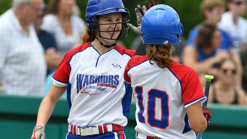 Northwestern senior Abby Zerkle (left) claps hands with Rachel Martin after scoring a run in a regional final against Columbus Ready on Saturday at Wright State. BRYANT BILLING / CONTRIBUTED