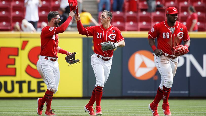 CINCINNATI, OH - APRIL 11: Michael Lorenzen #21, Jesse Winker #33 and Yasiel Puig #66 of the Cincinnati Reds celebrate after the game against the Miami Marlins at Great American Ball Park on April 11, 2019 in Cincinnati, Ohio. The Reds won 5-0. (Photo by Joe Robbins/Getty Images)
