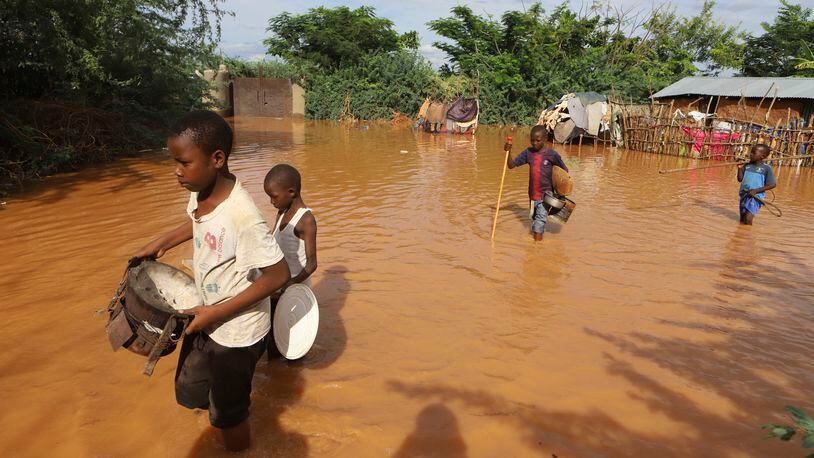 FILE - Children flee floodwaters that wreaked havoc at Mororo, border of Tana River and Garissa counties, Kenya, April 28, 2024. (AP Photo/Andrew Kasuku, File)