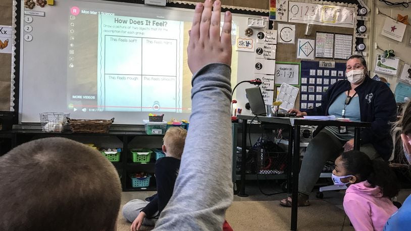 First-graders at Orchard Park Elementary School in Kettering work on an activity Tuesday March 2, 2021. The school is open for in-person learning after nearly a year of COVID-19 restrictions.
