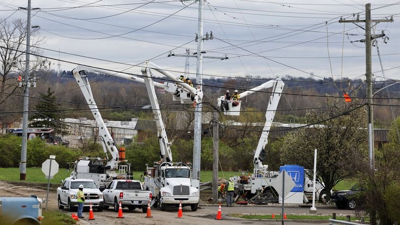 Crews work to replace utility poles Wednesday, April 3, 2024 the day after they fell on I-75 closing both directions of travel. NICK GRAHAM/STAFF