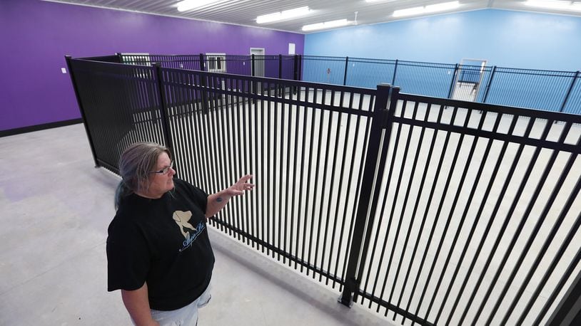 Several events will be held in Clark and Champaign Counties this weekend, including separate open houses at the Animal Welfare Leagues of Clark County and Champaign County, In this file photo, Tiger Franks, executive director of the Champaign County Animal Welfare League, talked about the new indoor dog park a few years ago, which will be open during the event. File/Bill Lackey/Staff