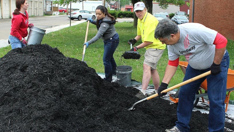 A group of workers from Speedway help with landscaping at the Salvation Army building in Springfield on April 28. Hundreds of people performed service projects across the Springfield community as part of the second Clark County Service Day, which is organized by the United Way of Clark, Champaign and Madison Counties. JEFF GUERINI/STAFF