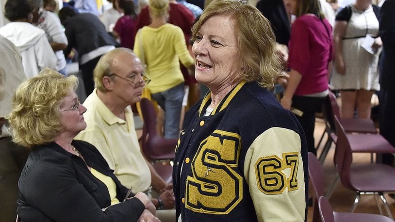 Linda Ehrle, a 1967 graduate of Springfield High School, was showing her school spirit as she toured the Springfield South building following a re-dedication ceremony Friday. Bill Lackey/Staff
