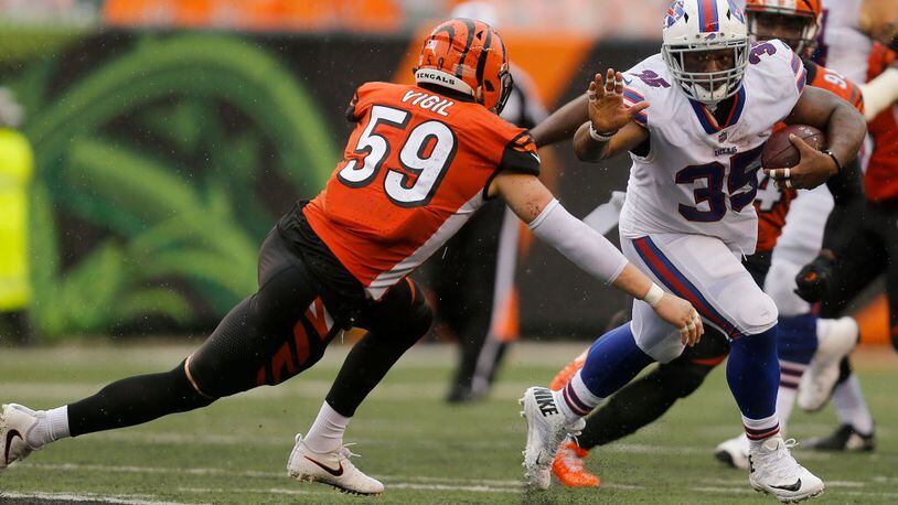 CINCINNATI, OH - OCTOBER 8: Nick Vigil #59 of the Cincinnati Bengals attempts to tackle Mike Tolbert #35 of the Buffalo Bills during the second quarter at Paul Brown Stadium on October 8, 2017 in Cincinnati, Ohio. (Photo by Michael Reaves/Getty Images)