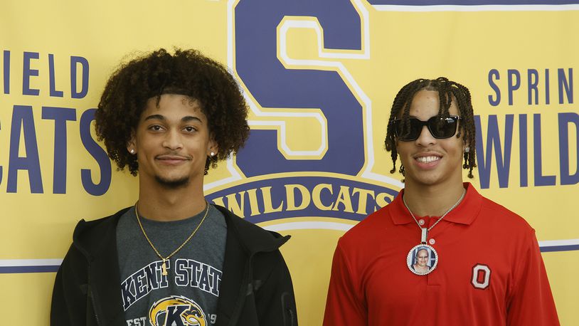 Springfield's Da Shawn Martin, left, signed his letter of intent to play football at Kent State University and Aaron Scott signed to play for Ohio State Wednesday, Dec. 20, 2023. BILL LACKEY/STAFF