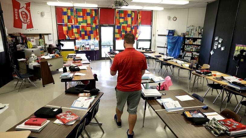 Clark and Champaign county school COVID-19 cases remain steady with 168 reported. Here, a teacher walks through his 5th grade classroom at South Vienna School while his students were at lunch. BILL LACKEY/STAFF