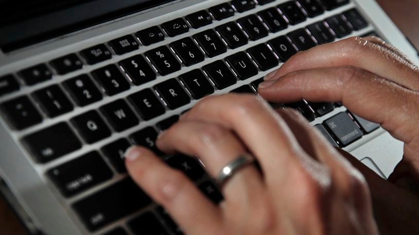 FILE - A person works on a laptop in North Andover, Mass., on June 19, 2017. Cyberattacks on businesses are rising, including small businesses. It’s a troubling trend that can be very costly and time consuming if owners don’t have a plan to deal with them. (AP Photo/Elise Amendola, File)