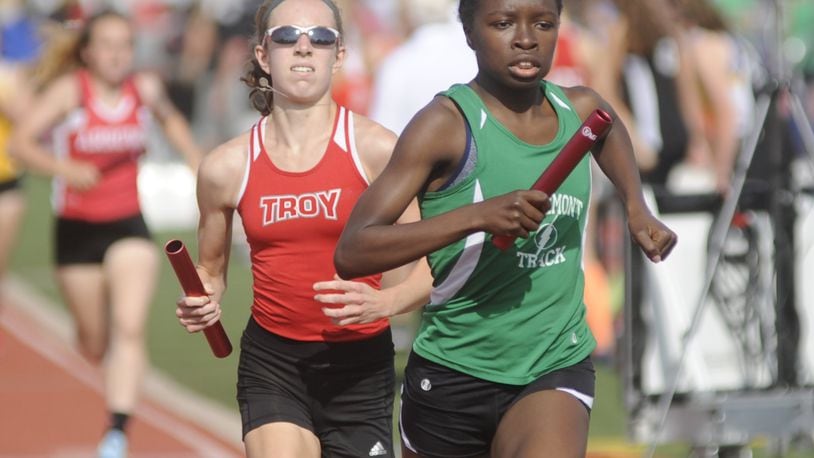 Northmont’s Melissa Barrett (right) takes a slight lead over Troy’s Morgan Gigandi in the 4x800 relay during the D-I district track and field meet at Wayne High School on Wednesday, May 17, 2017. MARC PENDLETON / STAFF