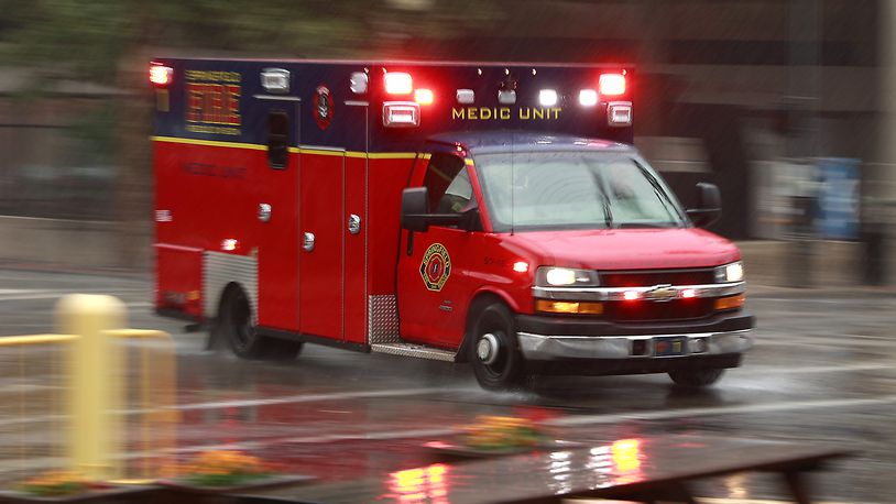 A Springfield Fire Rescue Division medic unit races through the rain downtown en route to a call Thursday, July 6, 2023. BILL LACKEY/STAFF