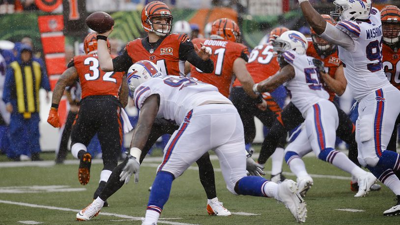 Cincinnati Bengals quarterback Andy Dalton, left, passes in the first half of an NFL football game against the Buffalo Bills, Sunday, Oct. 8, 2017, in Cincinnati. (AP Photo/Frank Victores)