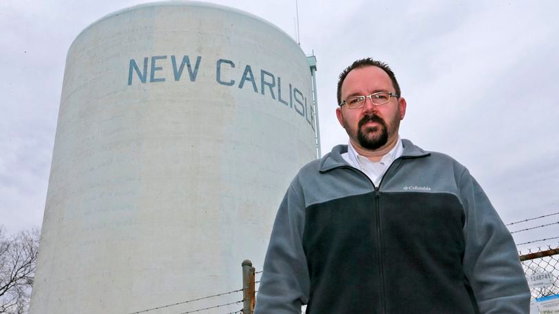 New Carlisle Mayor Mike Lowrey stands under the New Carlisle water tower in 2017. Bill Lackey/Staff