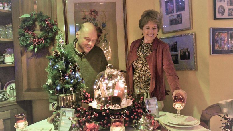 John Miller and Diana Begley discuss Begley’s design for the table to be featured at Miller’s home during the annual Tippecanoe Christmas in the Village home tour Dec. 2. CONTRIBUTED