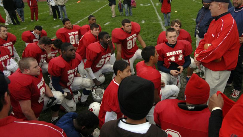 North football coach Jon Rommel, right, talks to the team following their victory over South in their last football game of the 2007 season. Staff photo by Bill Lackey