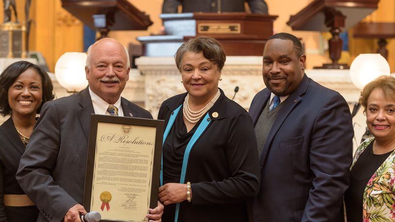 State Sen. Bob Hackett, R-London, presents Central State’s president a resolution of recognition.