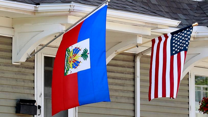 A residence along North Limestone Street in Springfield was flying the Haitian flag alongside the American flag Wednesday, May 10, 2023. BILL LACKEY/STAFF