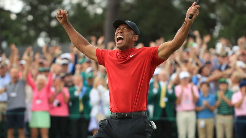 Tiger Woods (L) of the United States celebrates on the 18th green after winning the Masters at Augusta National Golf Club on April 14, 2019 in Augusta, Georgia. Woods is scheduled to be honored at the White House on Monday for his victory.
