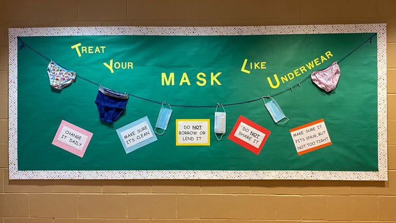 A bulletin board at Tecumseh Middle School reminding students and staff to wear a mask. CONTRIBUTED
