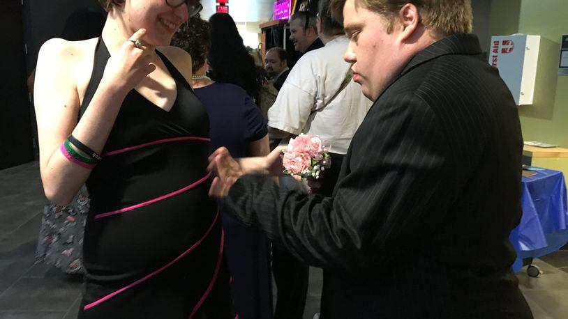 Zan Mullett offers a corsage to his date Taylor Brown at the Developmental Disabilities of Clark County s Spring Prom at the Hollenbeck Bayley Creative Arts and Conference Center on Wednesday. BRETT TURNER/CONTRIBUTING
