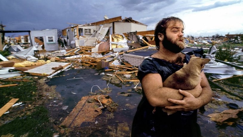 In this image, Palm Beach Post photographer Lannis Waters captured a moment of hope amid the misery after Hurricane Andrew chewed through south Dade County (now Miami-Dade) in 1992. Gary Davis cradles his chihuahua Boo-Boo. The two spent the night in his truck after fleeing his disintegrating mobile home.