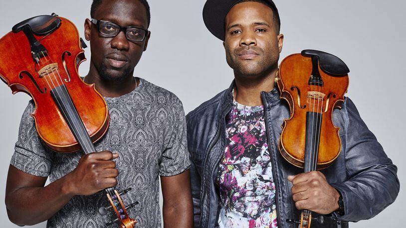Classically trained violist Wil B. (Wilner Baptiste, left) and violinist Kev Marcus (Kevin Sylvester), better known as Black Violin, will bring their “Classical Boom” tour to the Fraze Pavilion on June 28 featuring members of the Dayton Philharmonic Youth Orchestra. CONTRIBUTED