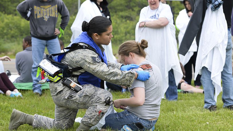 Staff Sgt. Jhosselin Alonzo, 88th Medical Operations Squadron paramedic, triages Airman 1st Class Chloe Ingram, National Air and Space Intelligence Center scientific applications technician, during a mass-casualty exercise at Wright-Patterson Air Force Base on May 5, 2016. U.S. AIR FORCE PHOTO/WESLEY FARNSWORTH
