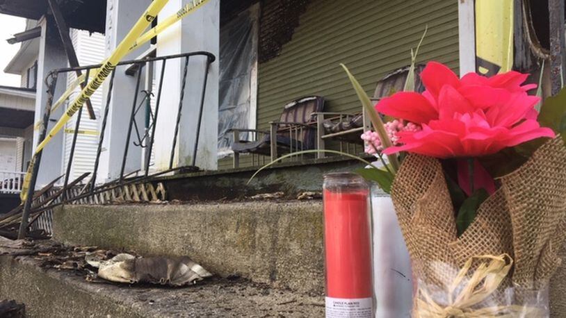 Candles and flowers were placed at a home on West Liberty Street in memory of a person who was found dead inside on Wednesday. That person has not been officially identified by investigators. JENNA LAWSON/STAFF