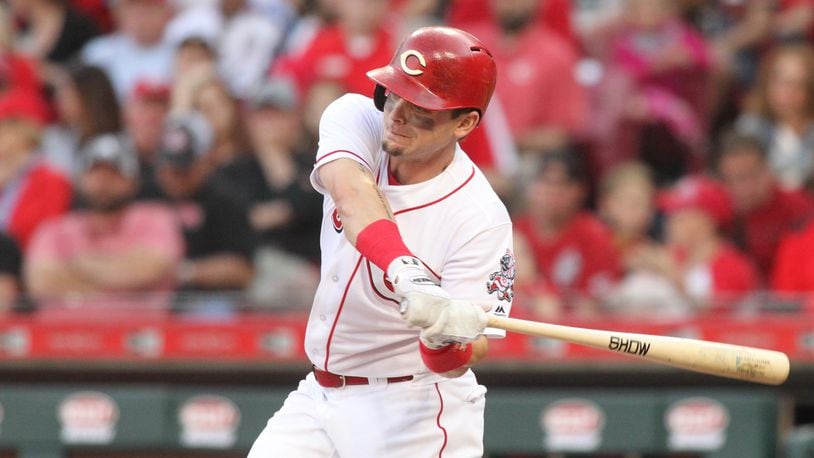 The Reds' Scooter Gennett swings during a game against the Mets on May 7, 2018, at Great American Ball Park in Cincinnati.