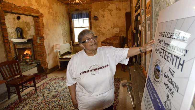 Betty Grimes looks over the sign on display in the Gammon House for the 2015 Juneteenth Celebration. Bill Lackey/Staff