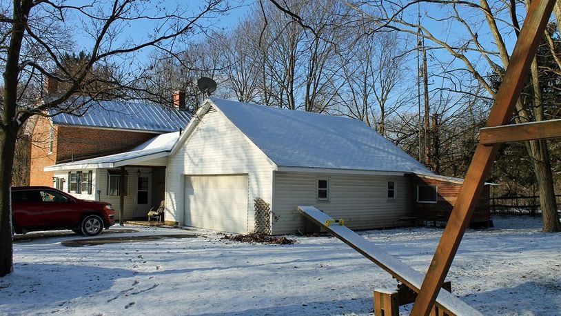 The Champaign county home is situated on 6 wooded acres. Exterior features include a 5-stall horse barn, a deck, a 3-acre pasture, a fenced yard, a gated, gravel driveway and a detached, 2-car workshop garage.