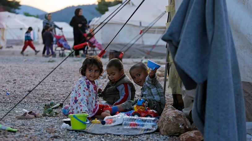 ATHENS, GREECE - MAY 18: Afghan refugee children play outside a tent in a refugee camp on May 18, 2016 in Malakasa, 40km north of Athens, Greece. According to the refugee Crisis Management Coordination Body's figures, 54,574 identified refugeees and migrants are on Greek territory. (Photo by Milos Bicanski/Getty Images)