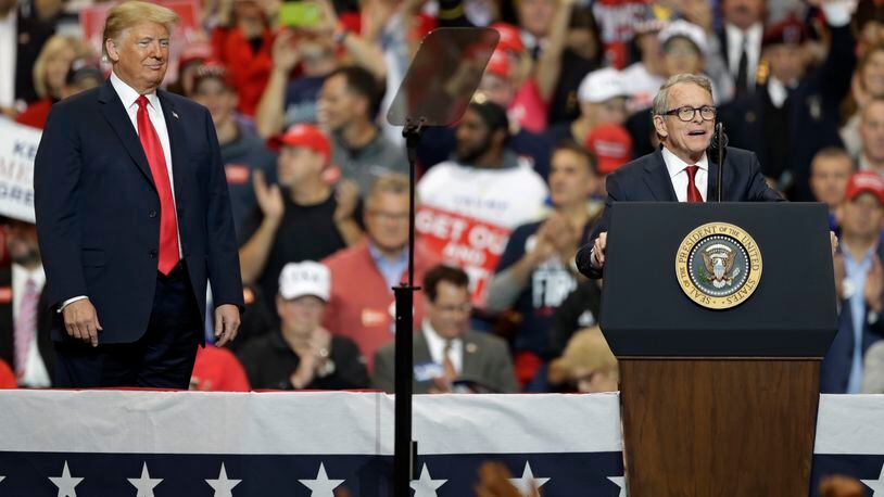 President Donald Trump, listens, as Ohio gubernatorial winner Mike DeWine speaks at a campaign rally in Cleveland for the 2020 presidential campaign. (AP Photo/Tony Dejak)