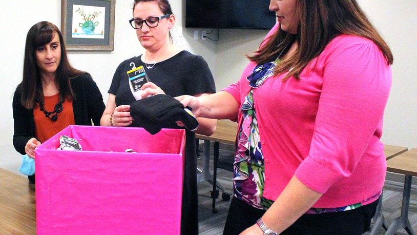 Champaign County Board of Developmental Disabilities employees (left) Sharon Wheeland, Erica Maze and Jennifer Bradford help collect socks for the Boards “Socktober” sock drive. JEFF GUERINI/STAFF