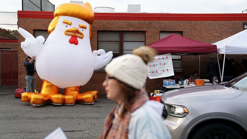 A cartoon chicken made to resemble President Donald Trump is inflated outside a polling place at Washington Mill Elementary School November 7, 2017, in Alexandria, Virginia. A similar looking balloon with a "Prisoner 45" shirt will fly in San Francisco Sunday.  (Photo by Chip Somodevilla/Getty Images)