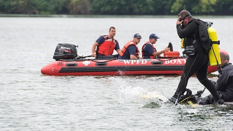 A diver from the 788th Civil Engineer Squadron Fire Department steps into the water to search for a reported drowning subject as part of a base exercise at Wright-Patterson Air Force Base July 31, 2018. Approximately a quarter of the base firefighters are dive qualified as the department is responsible for water rescue for several lakes on base and a portion of the Mad River. U.S. AIR FORCE PHOTO/WESLEY FARNSWORTH
