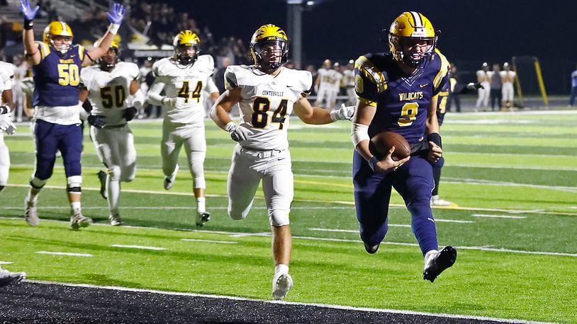 Springfield quarterback Bryce Schondelmyer leaps into the end zone to score a touchdown for the Wildcats during the playoff game against Centerville. BILL LACKEY/STAFF