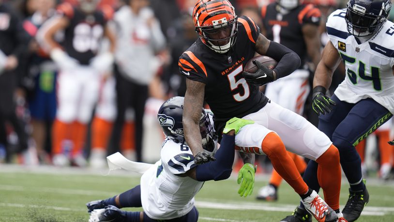 Cincinnati Bengals' Tee Higgins (5) is tackled by Seattle Seahawks' Quandre Diggs (6) during the first half of an NFL football game, Sunday, Oct. 15, 2023, in Cincinnati. (AP Photo/Michael Conroy)