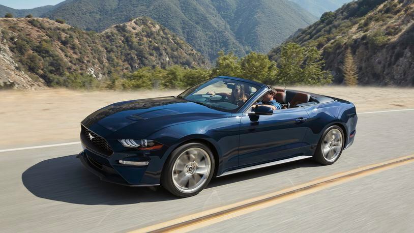 This photo provided by Ford shows the Ford Mustang convertible, a high-octane pony car. Its four-seat configuration makes it more practical than many rivals. (Courtesy of Ford Motor Co. via AP)