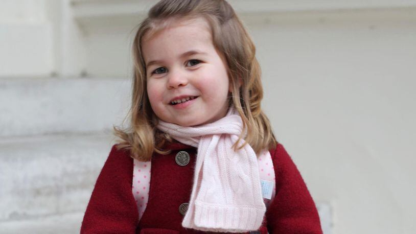In this handout picture provided by the Duke and Duchess of Cambridge, Britain's Princess Charlotte smiles as she prepares for her first day of nursery at the Willcocks Nursery School, in London, Monday, Jan. 8, 2018. (Duchess of Cambridge via AP)