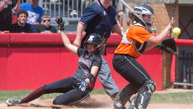 Lebanon’s Kat Frank scores ahead of the throw to North Canton Hoover catcher Laurel DeVoe during the 2017 Division I state semifinal at Firestone Stadium in Akron. ROBERT ROSSITER/THE CANTON REPOSITORY