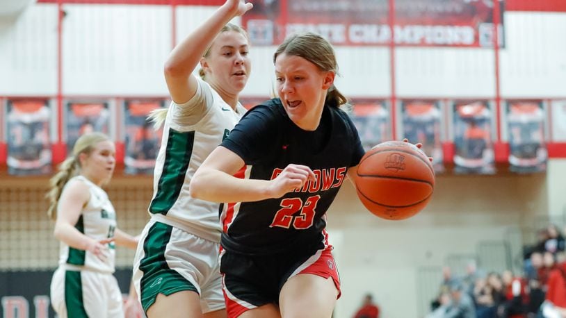 Tecumseh High School senior Gabrielle Russell drives past Greenville sophomore Megan Lind during their Division II first round tournament game on Monday night at Trotwood Madison High School. Michael Cooper/CONTRIBUTED