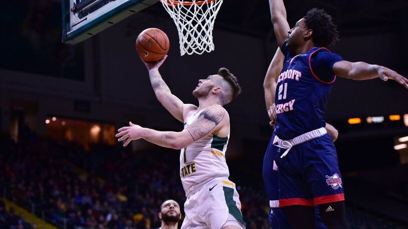 Wright State’s Bill Wampler scores as Detroit Mercy’s Lamar Hamrick defends during a game this season at the Nutter Center. Joseph Craven/CONTRIBUTED