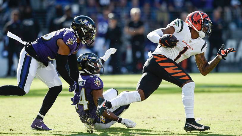 Baltimore Ravens safety Chuck Clark (36) and cornerback Marlon Humphrey (44) miss a tackle of Cincinnati Bengals wide receiver Ja'Marr Chase (1) before he took off for a long touchdown on a reception during the second half of an NFL football game, Sunday, Oct. 24, 2021, in Baltimore. (AP Photo/Gail Burton)