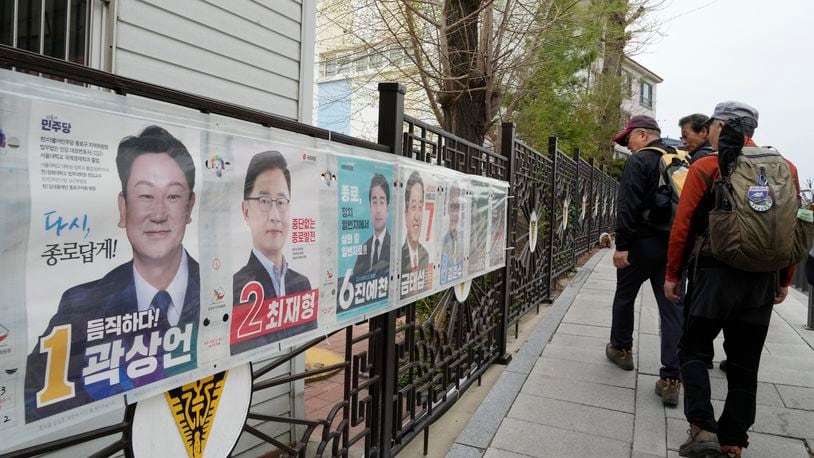 People pass by posters of candidates running for the upcoming parliamentary election in Seoul, South Korea, Wednesday, April 3, 2024. As South Koreans prepare to vote for a new 300-member parliament next week, many are choosing their livelihoods and other domestic topics as their most important election issues. This represents a stark contrast from past elections, which were overshadowed by security and foreign policy issues like North Korean nuclear threats and the U.S. security commitment.(AP Photo/Ahn Young-joon)
