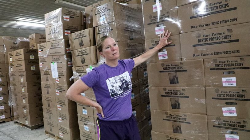 Jeanne Rue talks about the distribution of their Rue Farms Rustic Potato Chips to at least seven states Wednesday in the warehouse of their new 11 thousand square foot facility on US 68. BILL LACKEY/STAFF