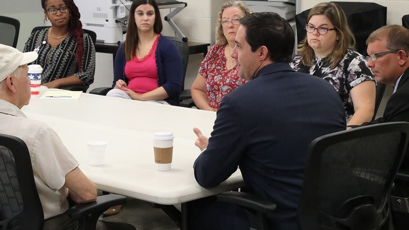 Ohio Secretary of State Frank LaRose talks with workers at the Clark County Board of Elections Thursday before a tour of the facility. BILL LACKEY/STAFF